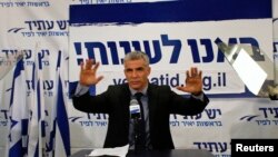 Yair Lapid, leader of the Yesh Atid (There is a Future) party, gestures in front of supporters at his party's headquarters in Tel Aviv, Israel, January 23, 2013.