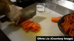 Ekber Kayser, chef and owner of Dolan Uyghur Restaurant, slices carrots before he makes polo.