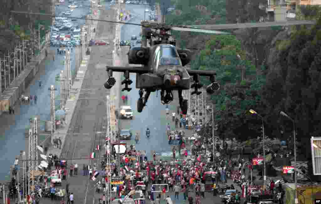A military attack helicopter flies near the presidential palace in Cairo, Egypt, Friday, July 5, 2013. 