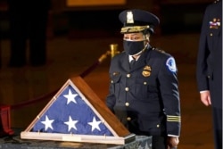 FILE - Acting U.S. Capitol Police Chief Yogananda Pittman pays respects to U.S. Capitol Police officer Brian Sicknick in the Capitol Rotunda in Washington, Feb. 2, 2021.