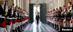 French President Emmanuel Macron walks through the Galerie des Bustes (Busts Gallery) to access the Versailles Palace's hemicycle to address both the upper and lower houses of the French parliament (National Assembly and Senate) at a special session in Ve