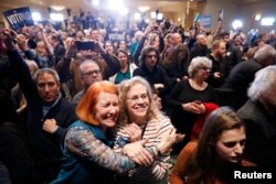 Supporters of U.S. Democratic congressional candidate Conor Lamb react to results coming in during Lamb's election night rally in Pennsylvania's 18th Congressional District special election against Republican candidate Rick Saccone in Canonsburg, Pennsylvania, March 13, 2018.