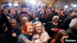 Supporters of U.S. Democratic congressional candidate Conor Lamb react to the results coming in during Lamb's election night rally in Pennsylvania's 18th Congressional District special election against Republican candidate and State Rep. Rick Saccone in C