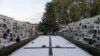 FILE - A man walks past a big tombstone commemorating those who died during the Spanish Civil War, at a cemetery ahead of All Saints Day, in Ronda, Spain, Oct. 28, 2020. 