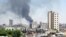 Smoke rises from buildings hit by shelling in Homs, Syria
