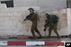 Israeli soldiers conduct a search for suspects of a shooting attack on Dec. 9, 2018 in the West Bank City of Ramallah, Dec. 10, 2018.