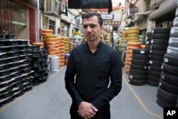Mehdi Abedi, a 30-year-old tire dealer, speaks at a market, in downtown Tehran, Iran, Oct. 8, 2017.