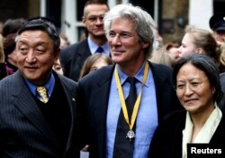 FILE - Actor and activist Richard Gere is flanked by and Lodi Gyari, left, special envoy of the Dalai Lama and Tsering Jampa, right, Chairman of the ICT after the Geuzen Penning ceremony in Vlaardingen, The Netherlands, March 12, 2005.