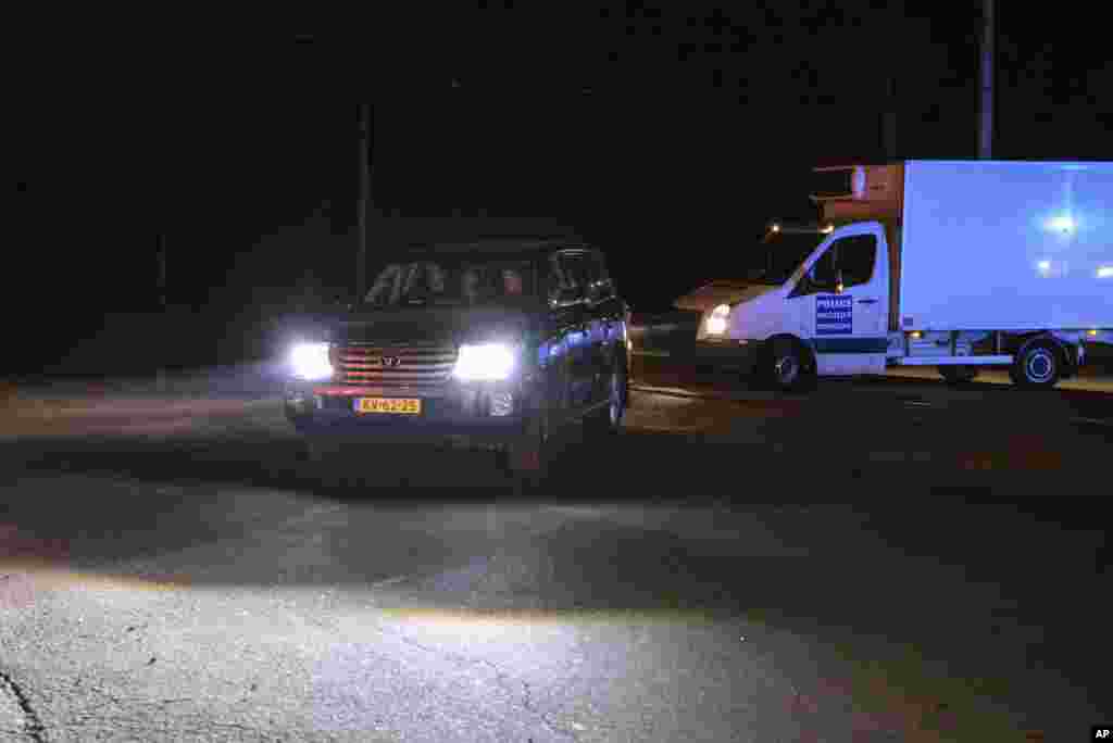 A convoy of refrigerated trucks loaded with bodies of the passengers of Malaysia Airlines Flight MH17 arrives at a Kharkiv factory in Kharkiv, Aug. 3, 2014.