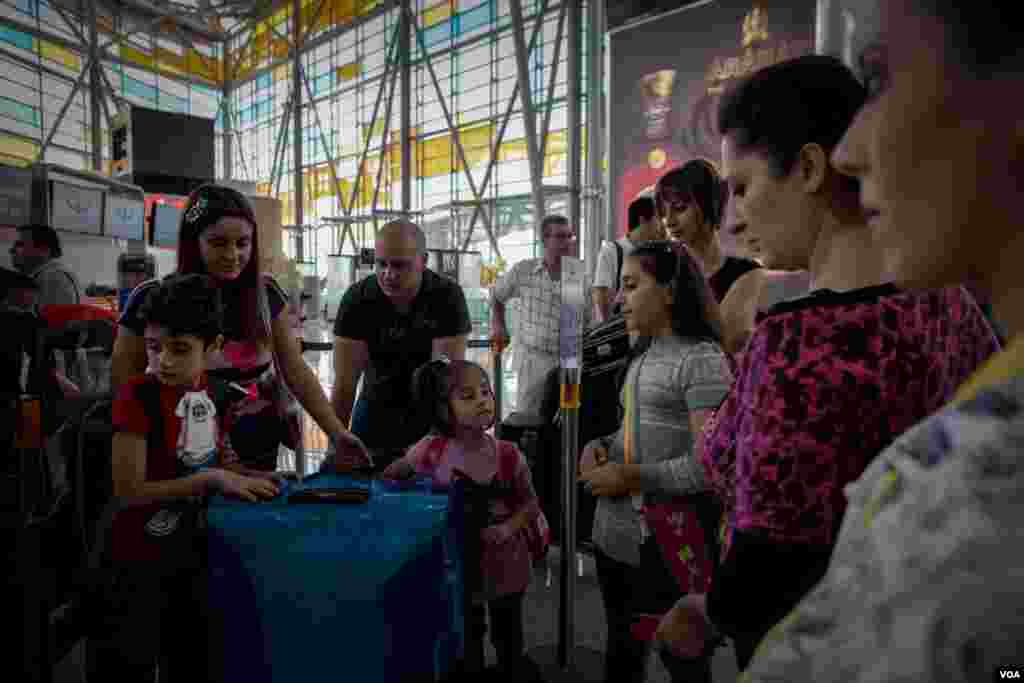 A Syrian-Armenian family waits at the departure gate at Zvartnots Airport in Yerevan, Armenia, December 2012. (VOA/D. Markosian)