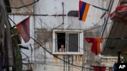 FILE - Armenian national flags hang from apartment balconies in the main Armenian district of the northern Beirut suburb of Bourj Hammoud, Lebanon, Oct. 6, 2020. 