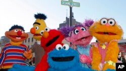 FILE - Characters from Sesame Street Live appear on the street by Madison Square Garden to celebrate the 30th anniversary of the live touring stage shows based on the PBS television series in New York, Thursday, Feb. 4, 2010.