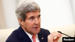 U.S. Secretary of State John Kerry gestures as he speaks to Chinese Foreign Minister Wang Yi (not seen) during their meeting at the Ministry of Foreign Affairs in Beijing, Feb. 14, 2014. 