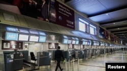 FILE - International check-in counters stand empty as several airlines stopped flying out of South Africa, amidst the spread of the new SARS-CoV-2 variant Omicron, at O.R. Tambo International Airport in Johannesburg, South Africa, Nov. 28, 2021.