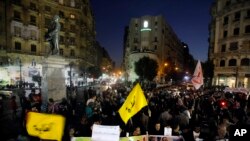 Egyptian protesters chant slogans in Talaat Harb Square in Cairo, Egypt, against the issuance of a new law regulating demonstrations, Thursday, Nov. 28, 2013.