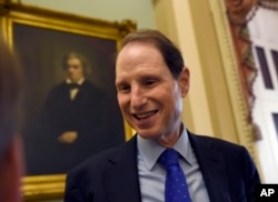 FILE - Sen. Ron Wyden, D-Ore. talks with a reporter on Capitol Hill in Washington, May 22, 2015.