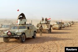Iraqi forces' vehicles are seen after the fighters captured Rawa town, the last remaining town under Islamic State control, Nov. 17, 2017.