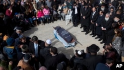 Family and friends of Israeli Dafna Meir attend her funeral in a cemetery in Jerusalem, Jan. 18, 2016.