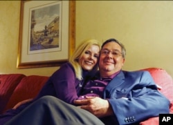 Martin Murphy and Rebecca Ward of Orlando, Fla., pose for a photograph in their room inside New York's Waldorf Astoria, Feb. 28, 2017. Two hotel regulars, Ward, 50, and her fiance, Murphy, 51, returned for two days to celebrate their engagement.