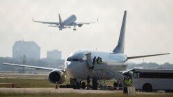 An airplane chartered to transport people to Haiti prepares to board passengers at the San Antonio International Airport as U.S. authorities accelerate the removal of migrants at the border with Mexico, in San Antonio, Texas, Sept. 20, 2021.