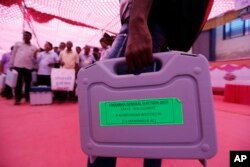 Officials on election duty carry electronic voting machines ahead of the general election in Ahmadabad, India, April 22, 2019.