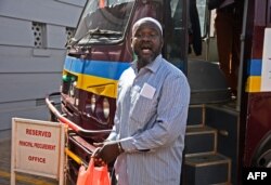 Allied Democratic Forces (ADF) rebel leader Jamil Mukulu reacts as he arrives on his first day of appearance at the Uganda High Court in Kampala on May 14, 2018.