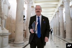 FILE - House Foreign Affairs Committee Chair Eliot Engel, D-N.Y., walks through the Hall of Columns at the Capitol as House Democratic chairs gather for a meeting with Majority Leader Steny Hoyer, D-Md., in Washington, March 27, 2019.