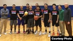 Players for the Cambodia National Basketball Team are pictured with the founders of the USA Cambodia Basketball Association, at Costello Athletic Center in Lowell, Massachusetts, March 12, 2017.