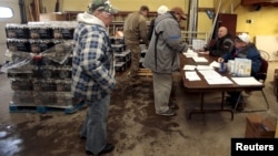 Flint residents pick up bottled water and water filters at a fire station in Flint, Michigan, Jan. 13, 2016.