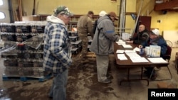 Flint residents pick up bottled water and water filters at a fire station in Flint, Michigan, Jan. 13, 2016.
