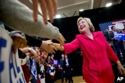 FILE - Democratic presidential candidate Hillary Clinton, center, arrives to speak at a get out the vote event at Transylvania University in Lexington, Ky., Monday, May 16, 2016.