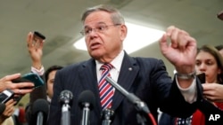 FILE - Sen. Bob Menendez, D-N.J., speaks to members of the media after leaving a closed door meeting about Saudi Arabia with Secretary of State Mike Pompeo, Nov. 28, 2018, on Capitol Hill in Washington.