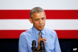 President Barack Obama pauses while speaking about the Flint, Michigan, water crisis, Jan. 20, 2016, at the United Auto Workers-General Motors Center for Human Resources in Detroit.