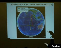 FILE - Malaysian Lieutenant General Ackbal Samad shows a map showing possible track of flight MH370 to relatives of passengers during a briefing by the Malaysian government at the Lido Hotel in Beijing, March 26, 2014.