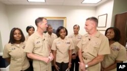 A screen grab from the U.S. Navy's Facebook Live event on Tuesday, July 10, 2018. Chief of Naval Operations Adm. John Richardson is joined by servicewomen for the announcement on policy changes regarding hairstyles. (Courtesy of U.S. Navy via AP)