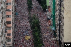 Protesters march during a rally against a controversial extradition law proposal in Hong Kong on June 9, 2019.