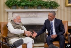 President Barack Obama reaches to shake hands with Indian Prime Minister Narendra Modi during their meeting in the Oval Office of the White House in Washington, June 7, 2016.