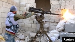 A Group 16 fighter, part of the Free Syrian Army, fires his weapon during what activists said were violent clashes with forces loyal to Syria's President Bashar al-Assad in Ashrafieh, Aleppo January 25, 2015.
