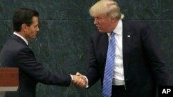 FILE - Mexico's President Enrique Pena Nieto and Republican presidential nominee Donald Trump shake hands after a joint statement at Los Pinos, the presidential official residence, in Mexico City, Aug. 31, 2016.