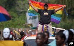 FILE - Ugandans take part in the 3rd Annual Lesbian, Gay, Bisexual and Transgender (LGBT) Pride celebrations in Entebbe, Uganda, Aug. 9, 2014.