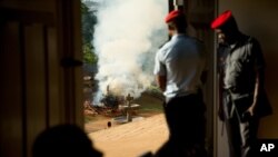 FILE - Officials watch from a distance as a pile of some 2,000 illegally trafficked elephant tusks and hundreds of finished ivory products are destroyed in the first ever Cameroonian burn of poached wildlife goods, April 19, 2016.