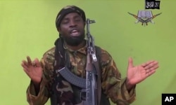 FILE - This image taken from video released by Boko Haram militants in Nigeria in May 2014 shows leader Abubakar Shekau, the group's most prominent leader.
