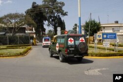 FILE - Bodies of Kenyan soldiers are transported by ambulances at Wilson airport, Nairobi, Kenya, Jan. 27, 2017. Extremist group al-Shabab said its fighters had killed at least 51 Kenyan soldiers in an attack on an army base in Kulbiyow, a town in Lower Jubba region.