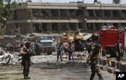 FILE - Security forces inspect the site of a massive suicide attack that killed more than 150, according to the Afghan president, in front of the German Embassy in Kabul, Afghanistan, May 31,2017. A letter drafted by a senior Islamic State militant points to a growing power struggle within the group’s Afghan affiliate.