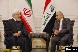 Iraq's Prime Minister Adel Abdul Mahdi meets Iranian President Hassan Rouhani in Baghdad, Iraq, March 11, 2019.