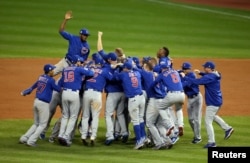 Chicago Cubs players celebrate after defeating the Cleveland Indians in game seven of the 2016 World Series in Ceveland, Ohio, Nov. 2, 2016.