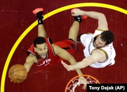 Toronto Raptors' Cory Joseph (6) shoots against Cleveland Cavaliers' Kevin Love (0) during the second half of Game 2 of the NBA basketball Eastern Conference finals Thursday, May 19, 2016, in Cleveland. The Cavaliers won 108-89.