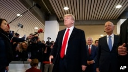 President Donald Trump talks with reporters as he arrives at the World Economic Forum, Jan. 26, 2018, in Davos.