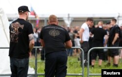 FILE - Participants arrive for one of Germany's biggest right-wing music festivals in Themar, Germany, July 15, 2017.