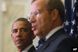 U.S. President Barack Obama, left, listens to Estonian President Toomas Hendrik Ilves during a news conference at the Bank of Estonia in Tallinn, Estonia, Sept. 3, 2014.